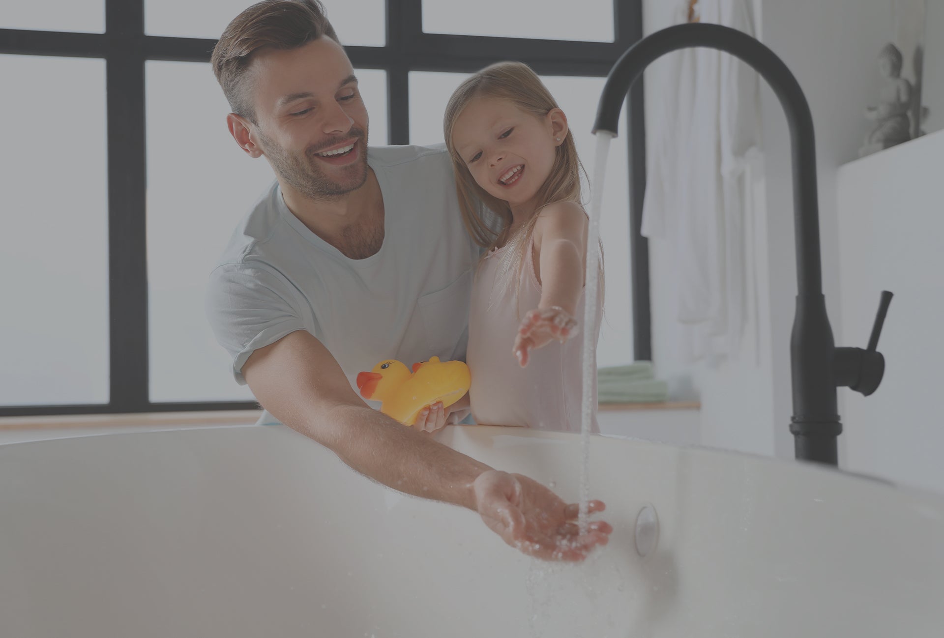 Dad and daughter testing the bath water