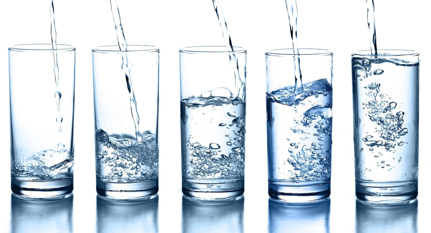clean water poured into 5 different glasses