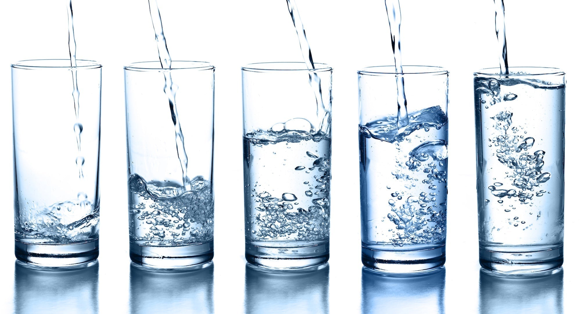 clean water poured into 5 different glasses