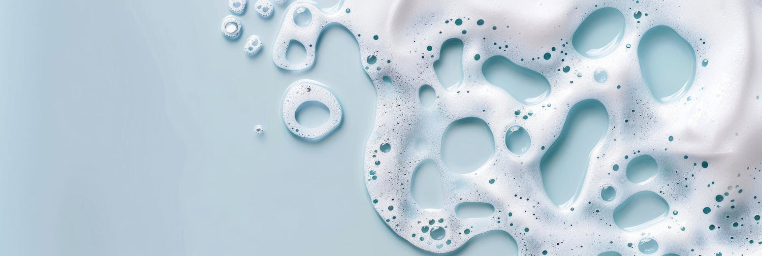 water and soap lather close up amidst a blue background