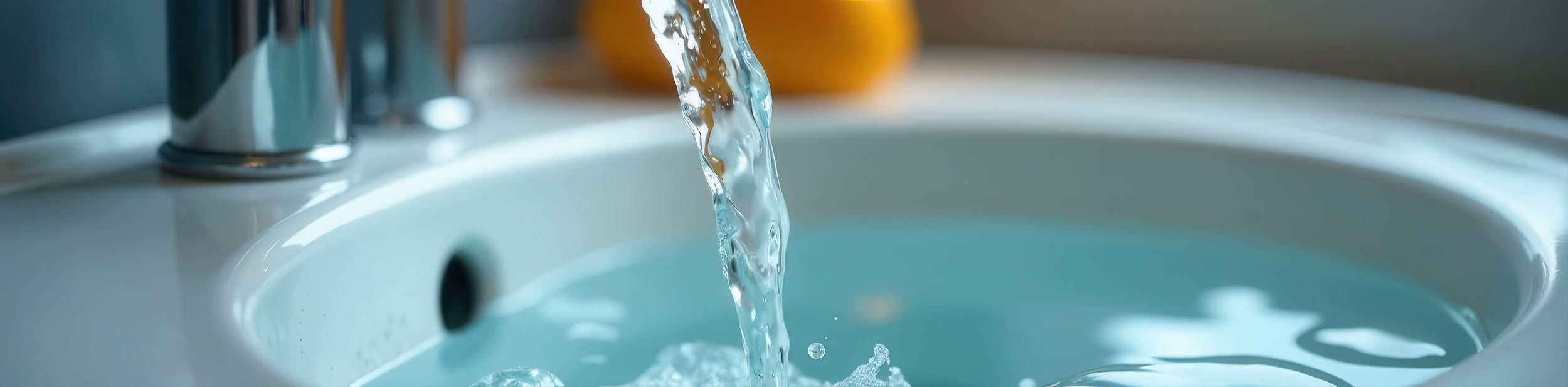  Close-up of soft water stream filling bathroom sink