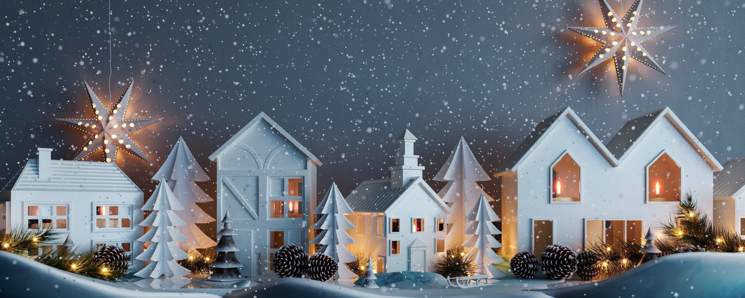 Snowy night with white paper houses and fir tree decoration